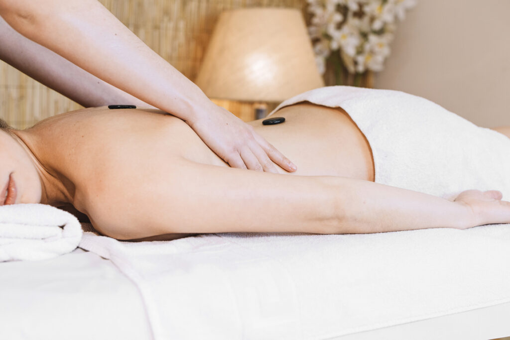 massage-concept-with-stones-womans-back
